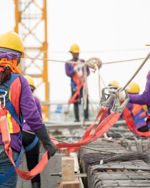 With the recent changes in Indonesia Construction Safety Standards, construction workers are now seen in safety gear handling rebar at a construction site.