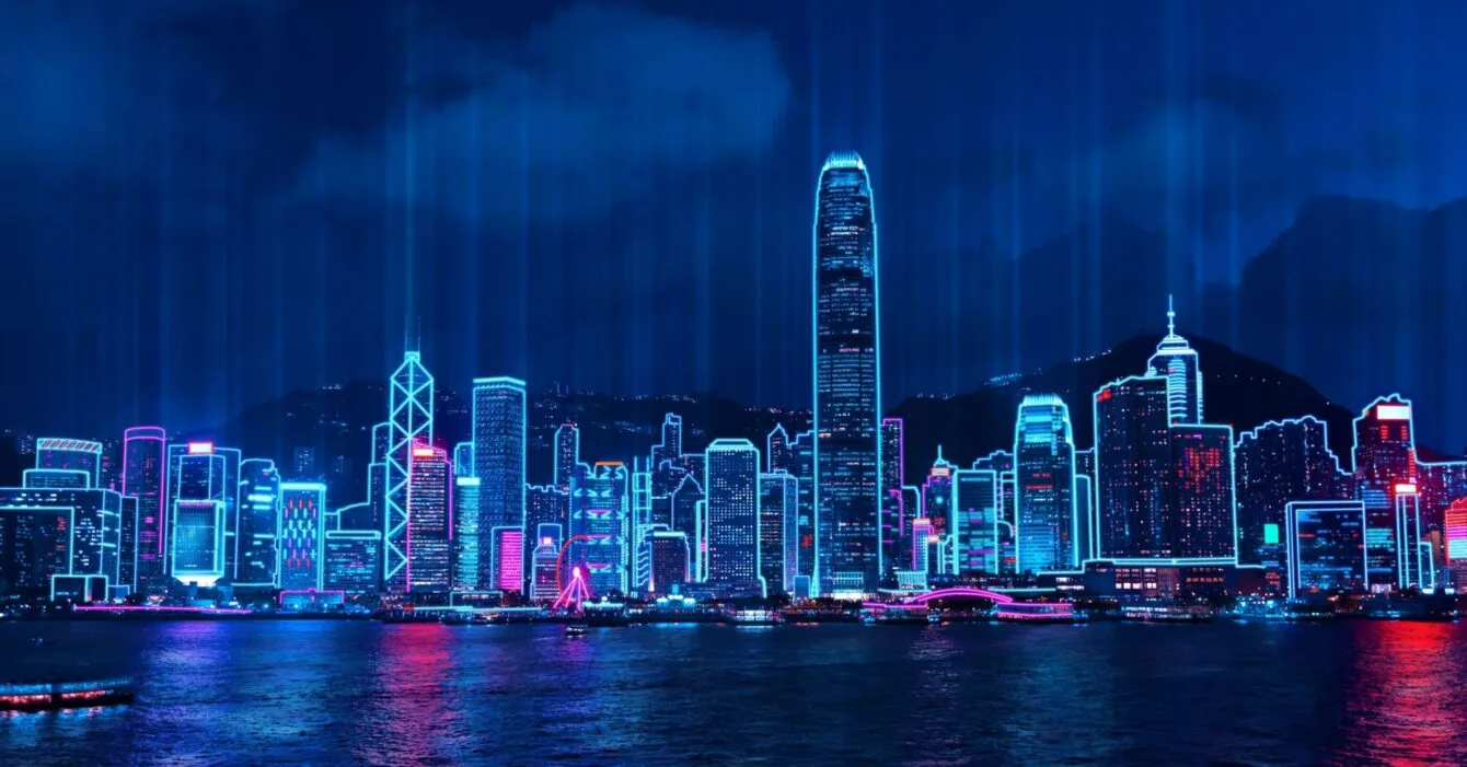 Indonesia Smart City Innovations: Neon-lit skyline of Hong Kong's Victoria Harbour at night with cyberpunk aesthetics.